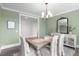 Light and bright dining area featuring sage green walls, wood floors, and stylish furnishings at 10310 Sablewood Dr # 211, Raleigh, NC 27617