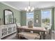 Stylish dining room with neutral decor, rustic table, and natural light creates a cozy space at 10310 Sablewood Dr # 211, Raleigh, NC 27617