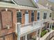 Charming brick townhome with a second-story balcony and white railing at 10310 Sablewood Dr # 211, Raleigh, NC 27617