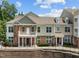 Attractive multi-story townhome with brick facade, second-floor balcony, and manicured landscaping at 10310 Sablewood Dr # 211, Raleigh, NC 27617