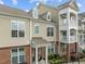Exterior view of brick and tan apartment complex with private balconies and well-kept landscaping at 10310 Sablewood Dr # 211, Raleigh, NC 27617