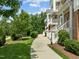 Well-maintained apartment complex exterior with landscaped walkways and green spaces at 10310 Sablewood Dr # 211, Raleigh, NC 27617
