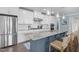 Modern kitchen featuring white cabinets, stainless steel appliances, and a large blue island at 10310 Sablewood Dr # 211, Raleigh, NC 27617