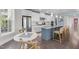 Modern kitchen featuring white cabinets, stainless steel appliances, and a blue island at 10310 Sablewood Dr # 211, Raleigh, NC 27617