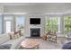 Cozy living room features a fireplace, neutral decor, and a large window at 10310 Sablewood Dr # 211, Raleigh, NC 27617