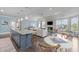 Bright open-concept living room with a modern kitchen island and a cozy seating area at 10310 Sablewood Dr # 211, Raleigh, NC 27617