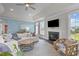 Bright living room with a fireplace, comfortable seating, and a view of the outdoors at 10310 Sablewood Dr # 211, Raleigh, NC 27617