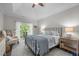 Comfortable main bedroom featuring a balcony, ceiling fan, and elegant decor for a relaxing retreat at 10310 Sablewood Dr # 211, Raleigh, NC 27617