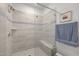 Clean shower design with tiled walls, a glass door, and built-in bench seating at 10310 Sablewood Dr # 211, Raleigh, NC 27617