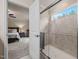 Bathroom with a glass shower wall and a bedroom in the background at 1038 Felman Rd, Durham, NC 27703