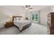A spacious bedroom featuring neutral colored walls, carpet and a ceiling fan at 1038 Felman Rd, Durham, NC 27703