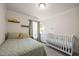 bedroom featuring a bed, crib and dresser with charming decor at 1038 Felman Rd, Durham, NC 27703