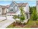 Two-story white home with well-manicured front yard and a side porch at 1038 Felman Rd, Durham, NC 27703