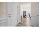 Foyer with hardwood floors leading to office space with bookcase and natural light at 1038 Felman Rd, Durham, NC 27703