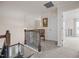 Upstairs hallway featuring neutral walls, plush carpet, and an open doorway at 1038 Felman Rd, Durham, NC 27703