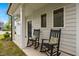 Inviting front porch featuring two rocking chairs and decorative pillows at 1038 Felman Rd, Durham, NC 27703