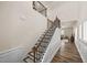Staircase with hardwood steps and decorative treads and decorative railings leading to the open living room at 1038 Felman Rd, Durham, NC 27703