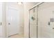 Clean bathroom features a tiled floor, a large glass-enclosed shower, and white walls at 105 Acorn Ridge Ln, Holly Springs, NC 27540