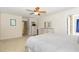 Bright bedroom features a ceiling fan, neutral walls and carpet, and a closet with an en-suite bath at 105 Acorn Ridge Ln, Holly Springs, NC 27540