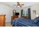 Comfortable bedroom with a queen-sized bed, dresser, and window with dark curtains at 105 Acorn Ridge Ln, Holly Springs, NC 27540