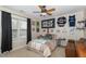 Cozy bedroom with a queen-size bed, ceiling fan, and playful decor at 105 Acorn Ridge Ln, Holly Springs, NC 27540