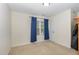 Minimalist bedroom featuring a window with curtains and a spacious layout at 105 Acorn Ridge Ln, Holly Springs, NC 27540