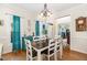 Open dining room featuring hardwood floors, natural light, and a view to other parts of the home at 105 Acorn Ridge Ln, Holly Springs, NC 27540