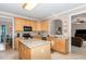 Spacious kitchen with an island, modern appliances, and granite countertops at 105 Acorn Ridge Ln, Holly Springs, NC 27540