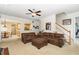 Bright living room with open floorplan, comfortable brown sectional, and view to kitchen at 105 Acorn Ridge Ln, Holly Springs, NC 27540