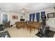 Spacious living room with neutral carpet, sofas, exercise equipment, and ceiling fan at 105 Acorn Ridge Ln, Holly Springs, NC 27540