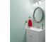 Bathroom featuring a white vanity, oval mirror, modern lighting, and refreshing mint green walls at 105 Otter Dr, Cary, NC 27513