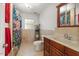 Well-lit bathroom features a shower with curtain, a vanity, and a mirrored medicine cabinet at 105 Otter Dr, Cary, NC 27513