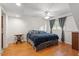 Spacious bedroom featuring hardwood floors, a ceiling fan, and bright windows at 105 Otter Dr, Cary, NC 27513