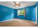 A cozy bedroom featuring a ceiling fan and a window with natural light at 105 Otter Dr, Cary, NC 27513