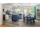 Bright kitchen with white cabinets, stainless steel appliances, an island, and an adjacent dining area at 105 Otter Dr, Cary, NC 27513