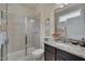 Well-lit bathroom with a glass-enclosed shower, granite countertop, and modern fixtures at 1120 Hooper Pl, Durham, NC 27703