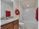 Neat bathroom featuring a granite vanity, toilet, and bathtub with shower, offering a refreshing space at 1120 Hooper Pl, Durham, NC 27703
