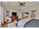 Bright bedroom featuring tray ceilings and large windows with natural light and wood floors at 1120 Hooper Pl, Durham, NC 27703