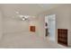 Expansive bonus room with carpeting, a ceiling fan, built-in shelving, and bathroom access at 1120 Hooper Pl, Durham, NC 27703