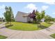 Well-maintained home exterior with manicured lawn, mature trees, and inviting curb appeal at 1120 Hooper Pl, Durham, NC 27703
