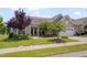 Beautiful home exterior with lush lawn, mature trees, and charming curb appeal in a serene neighborhood at 1120 Hooper Pl, Durham, NC 27703