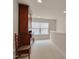 Bright hallway featuring a classic hutch, carpet, and natural light from a window overlooking the yard at 1120 Hooper Pl, Durham, NC 27703