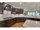 Stylish kitchen with dark cabinetry, granite counters, and a gas cooktop at 1120 Hooper Pl, Durham, NC 27703