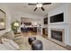Cozy living room featuring a fireplace, built-in shelving with a wet bar, and an open layout at 1120 Hooper Pl, Durham, NC 27703