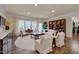 Bright living room featuring a decorative fireplace, hardwood floors, and large windows and elegant furniture at 1120 Hooper Pl, Durham, NC 27703