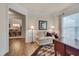 Inviting living room featuring a cozy couch, wainscoting, and hardwood floors, perfect for relaxation and entertaining at 1120 Hooper Pl, Durham, NC 27703