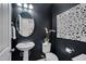 Chic powder room with a pedestal sink, elegant mirror, and modern decor at 1120 Hooper Pl, Durham, NC 27703