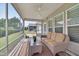 Relaxing screened porch featuring a comfortable wicker sofa, perfect for enjoying the outdoors at 1120 Hooper Pl, Durham, NC 27703