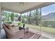 Relaxing screened porch with comfortable seating overlooking the lush backyard and landscaping at 1120 Hooper Pl, Durham, NC 27703