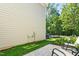 Cozy backyard patio with chairs overlooking well-maintained grass and lush trees at 1201 Somers Dr, Morrisville, NC 27560